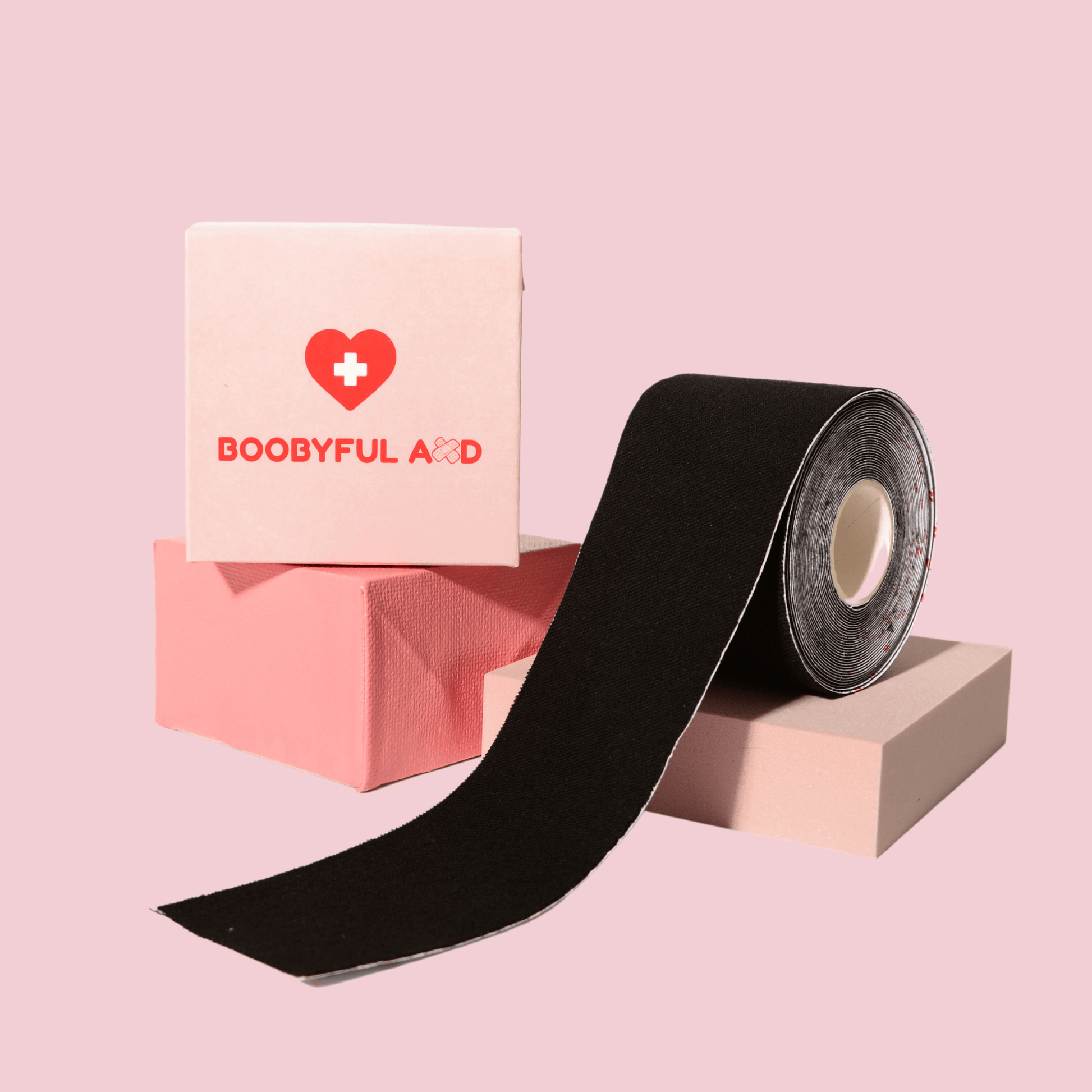 black boob tape photoshoot on pink cubes