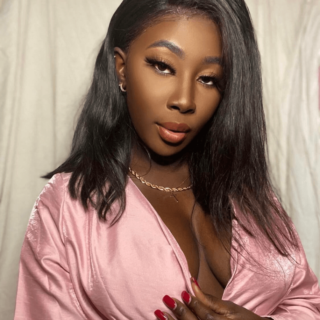 dark skinned girl in pink silk low cut v top using black boob tape